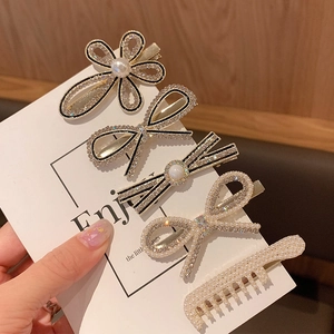 Detail view of 5-piece hair clip set featuring faux pearls and sparkling rhinestones