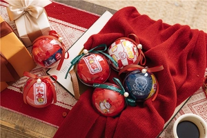 Close-up of red festive socks in a clear spherical gift box with elegant white ribbons
