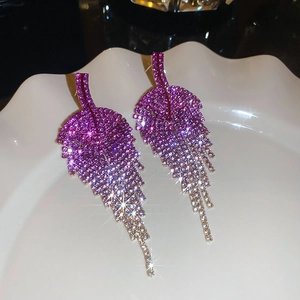 Macro shot of silver leaf tassel earrings with sparkling purple gradient rhinestones