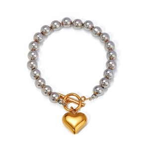 Elegant silver beaded bracelet with a golden heart pendant and T-bar toggle clasp