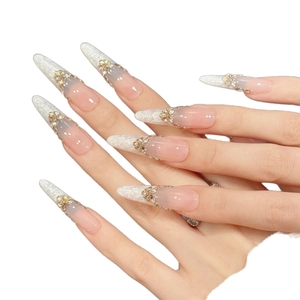 Pink lace press-on nails with golden butterfly and floral 3D jewelry accents