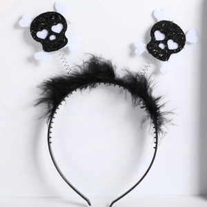 Halloween headband featuring black feathers and glittery skeleton skulls on springs