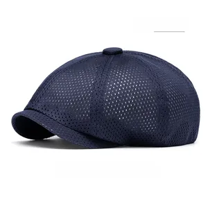 Close-up of navy blue breathable mesh fabric and top button on a summer beret hat