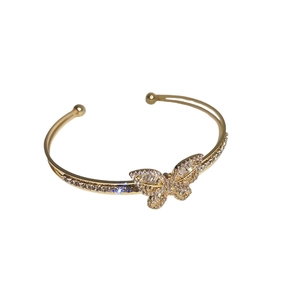 Gold plated butterfly open bangle with sparkling cubic zirconia on a white background