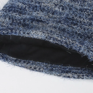Women's chunky knit beanie featuring blue and white boucle yarn and warm black lining