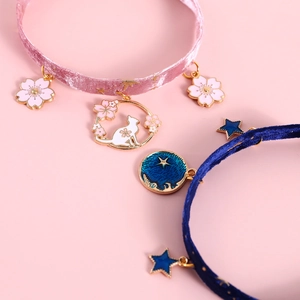 Detail of pink cherry blossom and blue starry velvet collars with adjustable alloy chains