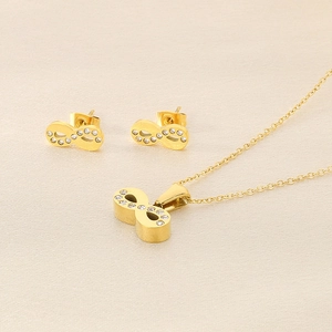 Detailed view of infinity pendant necklace and earrings set with crystal inlay