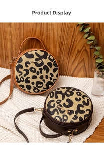 Detail of leopard print round bags with gold logo and detachable shoulder strap