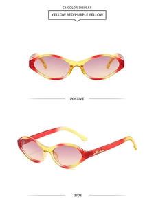 Detail of retro oval sunglasses showing gradient red-yellow frame and purple-yellow lenses