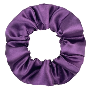 Macro shot of large purple satin scrunchie showing glossy texture and fabric folds