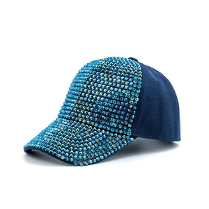 Detail showing high-density light blue rhinestones on a navy blue cotton baseball cap