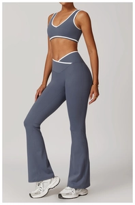 Detail of grey blue yoga set featuring a white trimmed V-neck bra and flared leggings