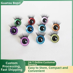 Close-up of colorful 3D doll eyes with long eyelashes and glitter finish for DIY crafts