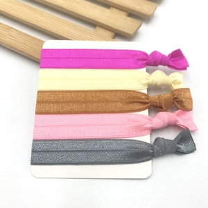 Set of five colorful knotted elastic hair bands on display card in diverse soft tones