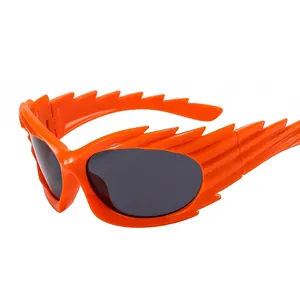 Sporty bright orange flame wing shaped sunglasses with round grey lenses on white background