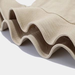 Detailed close-up of beige cotton fisherman hat brim with reinforced eight-row stitching