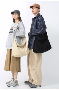 Corduroy tote bag in black and beige colors shown by models in a clean studio setting