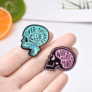 Punk style colorful skull enamel pins featuring creative lettering and artistic designs