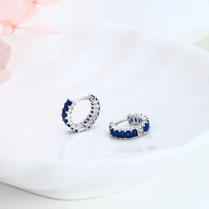 Detail view of S925 sterling silver hoop earrings with square blue zircon stones