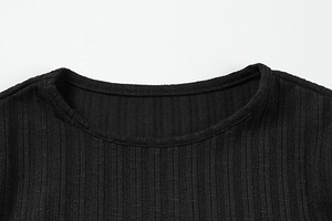 Detail of black ribbed knit round neckline with smooth flat stitching and high elasticity