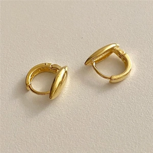 Detailed view of teardrop gold hoop earrings made of 925 sterling silver on white background