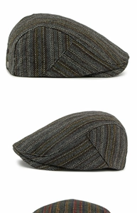 Close-up of the vintage herringbone tweed fabric texture on a wool newsboy flat cap