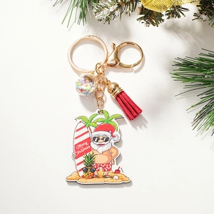 Detail of Santa Claus surfing keychain with red tassel and sparkling star sequins