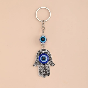 Vintage silver Hamsa Hand keychain with blue evil eye beads and ethnic carved patterns