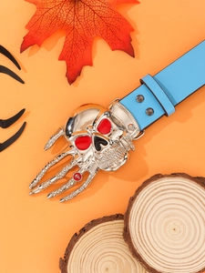 Detail of punk style skull and bone claw buckle on a light blue leather belt
