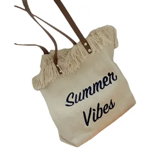 Chic woven tote bag with fringe trim, leather straps and Summer Vibes text embroidery