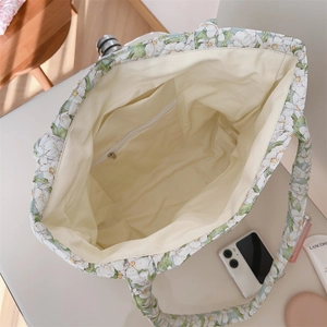 Macro shot of large floral tote bag interior featuring hidden zipper pocket and soft lining