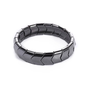 Magnetic black hematite bracelet with wide arrow-link design for men on white background