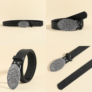 Close-up of black leather belt featuring an oval silver alloy buckle with floral engraving