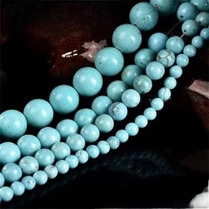 Macro shot of natural turquoise round beads with dark iron matrix for jewelry DIY