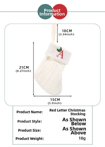 Detailed knit texture of white Christmas stocking with embroidered red letter A decoration