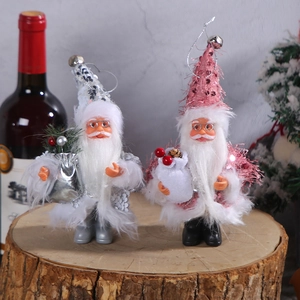5-inch Santa Claus figurines in silver and pink sequins on a rustic wooden stand
