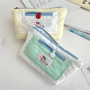 Detailed top view of large capacity canvas pencil cases with colorful zippers and logo
