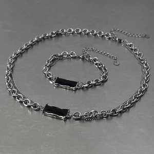 Detail view of multi-layer titanium steel chain set with black rectangular zircon stone