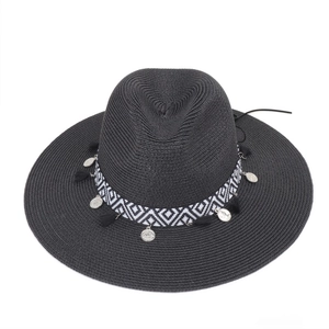 Detail of black straw fedora with bohemian geometric band and silver coin pendants