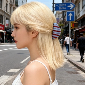 Close-up of blue and coffee striped hair claw clip styled on a model in outdoor setting