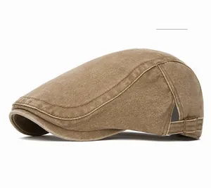 Detail view of adjustable metal side buckle and heavy washed khaki canvas on newsboy cap