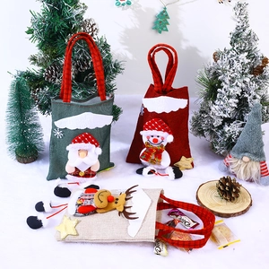 Three Christmas burlap gift bags with 3D Santa, snowman and reindeer plush figures