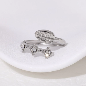 Polished silver leaf open ring with 18k plating and three sparkling cubic zirconia stones