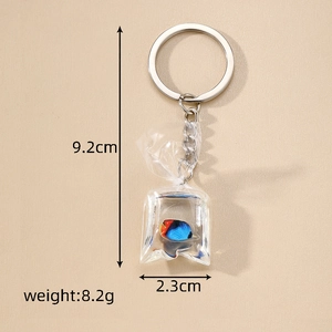 Detailed view of resin tropical fish keychain in water bag showing size and weight specs