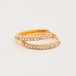 Macro detail of gold-plated stainless steel hoop earrings with sparkling zircon inlay
