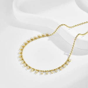 Detail of gold beaded chain necklace featuring sparkling zircon olive branch pendant design
