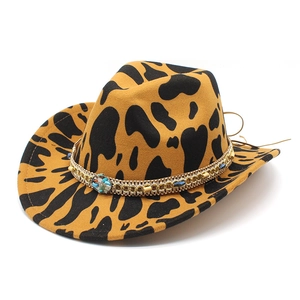 Close-up of cowboy hat with cow print pattern and decorative stone beaded chain