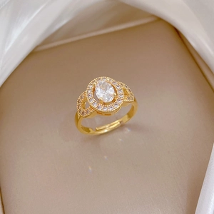 Close-up of golden adjustable ring with oval center stone and pavé zircon detailing