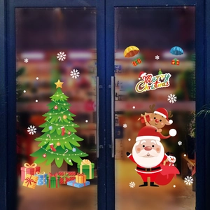Detail of Christmas window stickers featuring Santa Claus, reindeer, and a festive Xmas tree