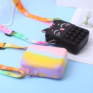 Detail of black cat and rainbow pop-it silicone bags with colorful nylon straps